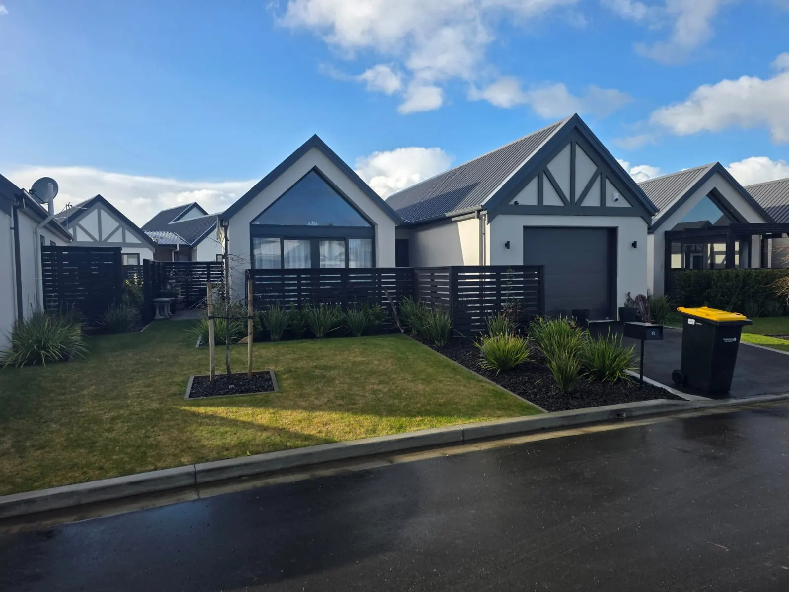 Finished gable-front homes with white plaster and dark accents