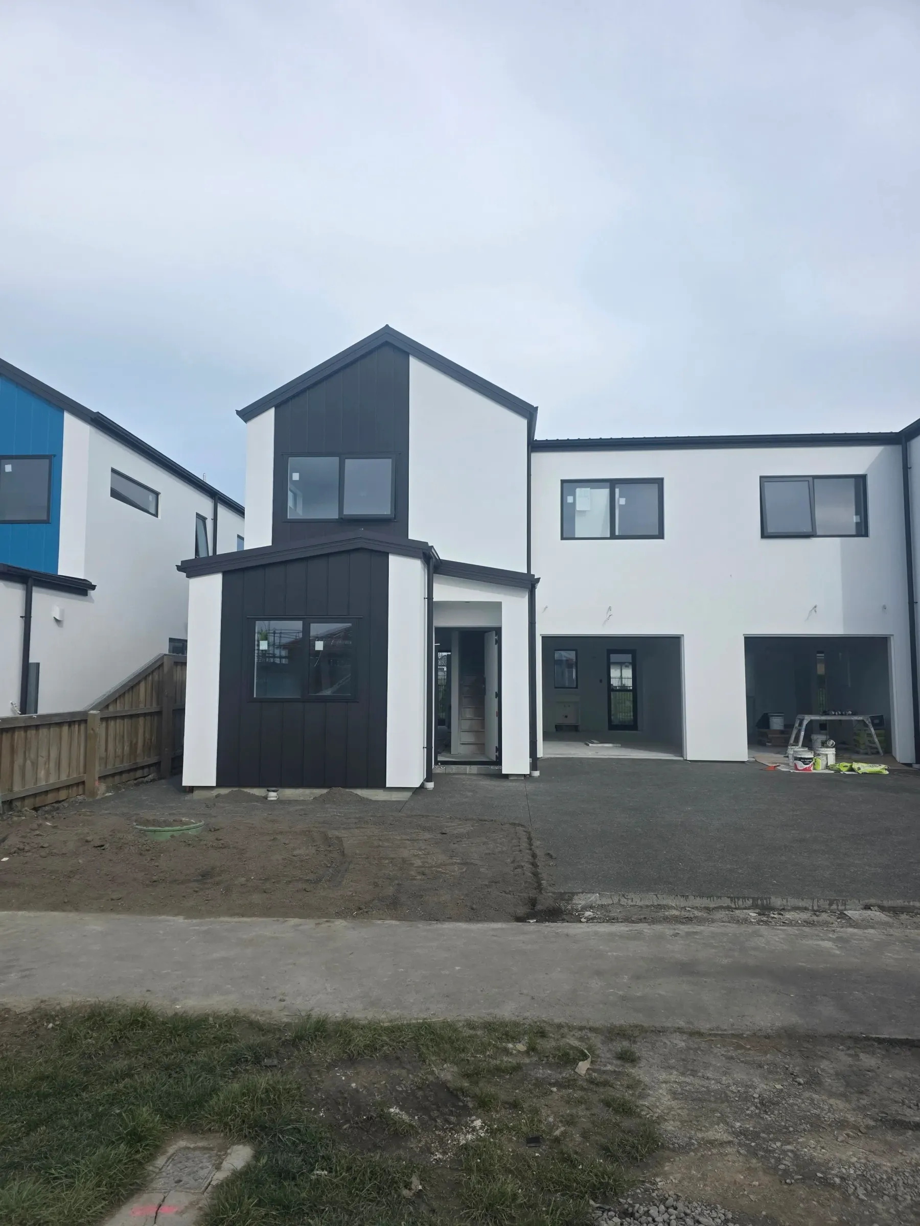 Townhouses with white plaster and charcoal cladding accents